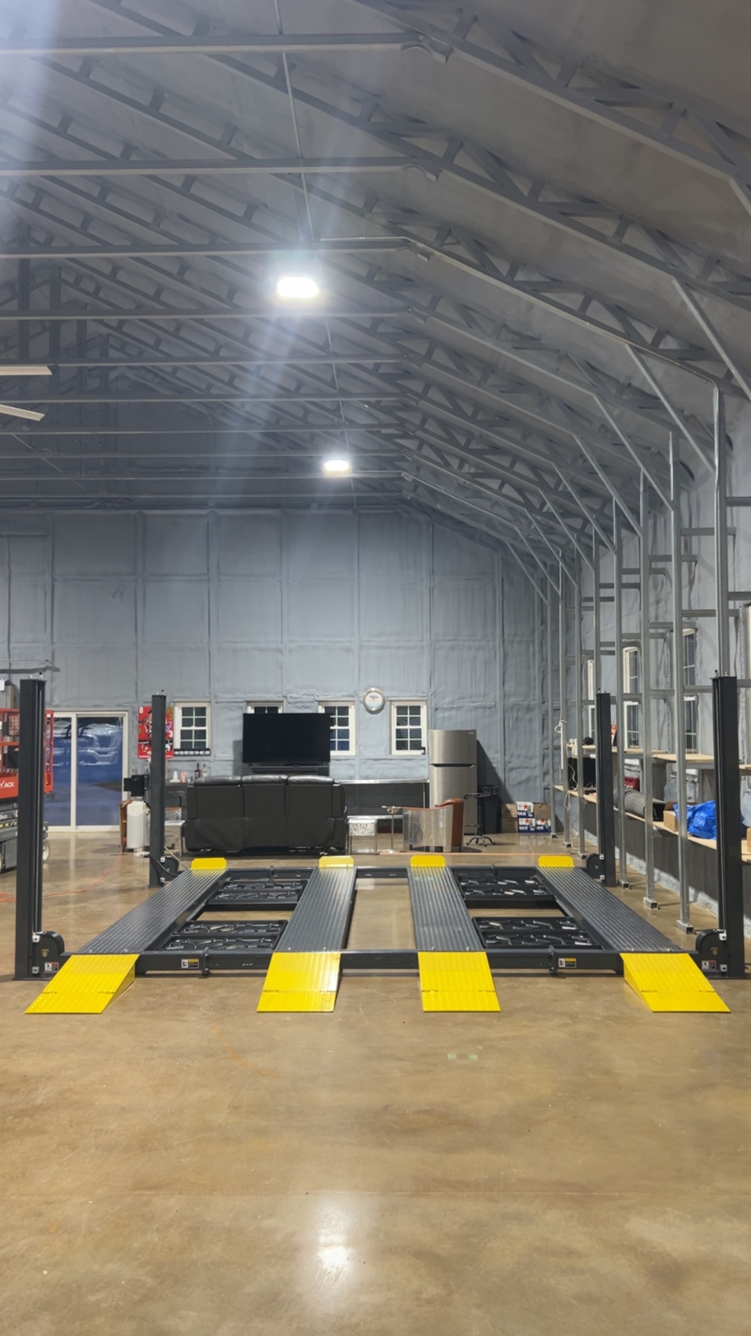 Four-post storage lift installed in a large steel building