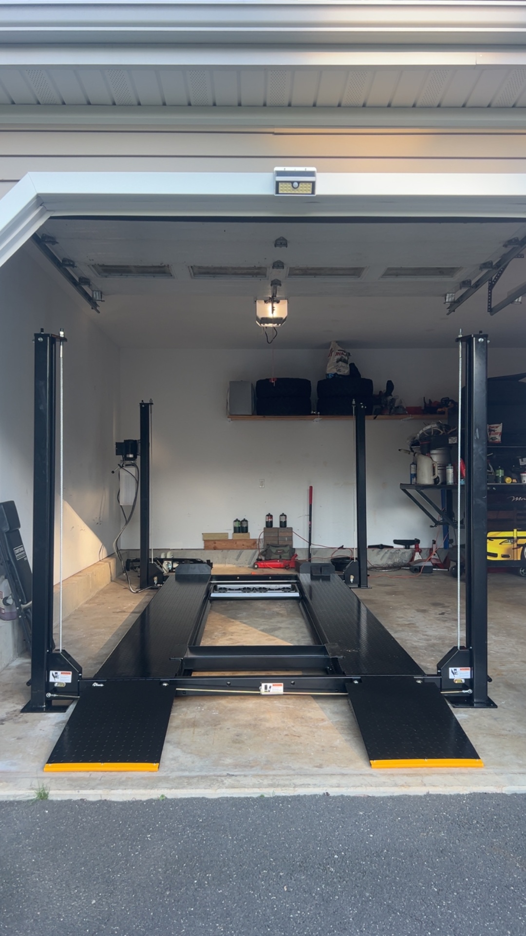 Four-post storage lift installed in a residential garage
