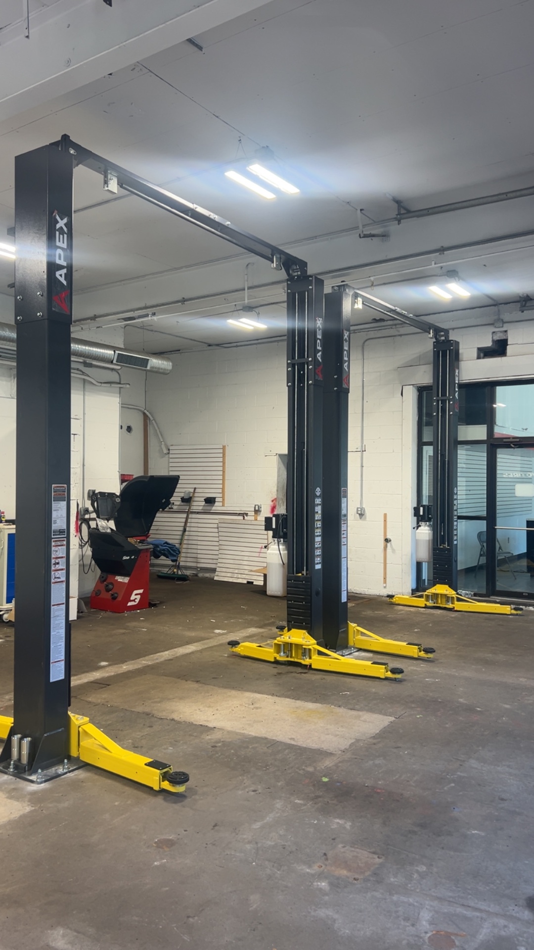 APEX two-post automotive lifts installed in a shop